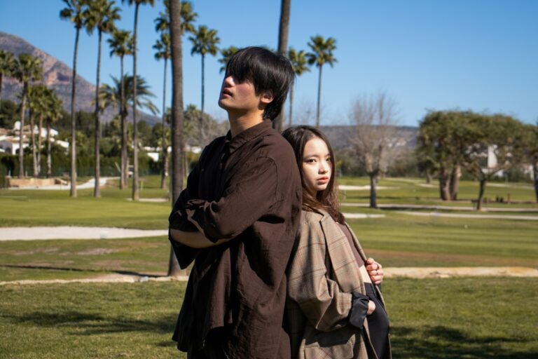 a man and woman standing together outside