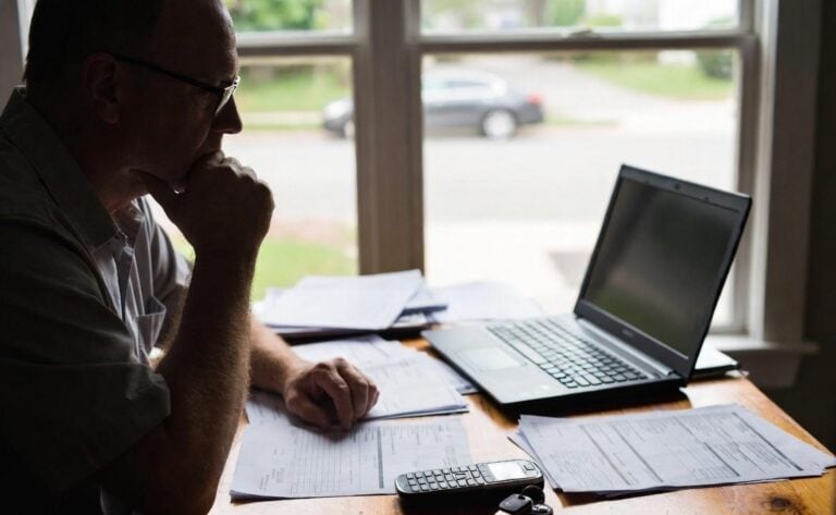 man reading insurance contract